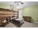 Inviting bedroom with wood accent wall and comfortable furnishings at 1267 Castleberry Dr, Buford, GA 30518