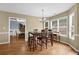 Light-filled dining area with wood floors, chandelier, and adjacent formal dining room at 1267 Castleberry Dr, Buford, GA 30518