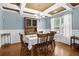 Elegant dining room featuring a decorative ceiling, classic chandelier, and wainscoting details at 1267 Castleberry Dr, Buford, GA 30518