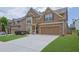 Charming exterior showcasing the home's facade, attached garage, and lovely landscaping on a sunny day at 1267 Castleberry Dr, Buford, GA 30518