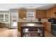 Bright kitchen with island, wood cabinets, and access to the backyard at 1267 Castleberry Dr, Buford, GA 30518
