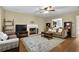Comfortable living room featuring a cozy fireplace, hardwood floors, and ample seating at 1267 Castleberry Dr, Buford, GA 30518