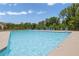 Community pool with clear blue water and lounge chairs for relaxation under the sun at 1267 Castleberry Dr, Buford, GA 30518