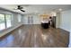 Bright, open-concept living room with hardwood floors connected to a modern kitchen at 6751 Davidson Ct, Lithonia, GA 30058