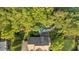 Aerial view of a large home with a manicured yard, pool, and putting green surrounded by trees at 1220 Waterfall Nw Ln, Acworth, GA 30101