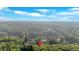Expansive aerial view of home nestled in a lush, green landscape with a private lake at 1220 Waterfall Nw Ln, Acworth, GA 30101