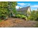 The backyard features natural landscaping, a pool, mature trees, and plenty of space for outdoor activities at 1220 Waterfall Nw Ln, Acworth, GA 30101