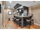Basement bar featuring modern appliances, leather stools and hardwood floors at 1220 Waterfall Nw Ln, Acworth, GA 30101
