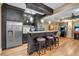 Finished basement bar area with a granite countertop, stainless steel appliances, and dark wood cabinetry at 1220 Waterfall Nw Ln, Acworth, GA 30101