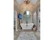 Bright bathroom with freestanding tub, stand alone shower, brick accent wall, and large arched window at 1220 Waterfall Nw Ln, Acworth, GA 30101