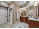 Bathroom with double sinks, granite countertops, and tile flooring at 1220 Waterfall Nw Ln, Acworth, GA 30101