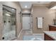 Elegant bathroom featuring a glass-enclosed shower with a stone floor and neutral tones at 1220 Waterfall Nw Ln, Acworth, GA 30101
