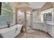 Bright bathroom featuring glass enclosed shower, granite countertops, double sink, and a stand alone tub at 1220 Waterfall Nw Ln, Acworth, GA 30101