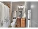 Bathroom featuring a shower-tub combo, toilet, and vanity with a mirror and lighting at 1220 Waterfall Nw Ln, Acworth, GA 30101