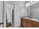 Bathroom with double sinks, wood cabinetry, and modern lighting at 1220 Waterfall Nw Ln, Acworth, GA 30101