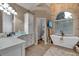 Bright bathroom featuring granite countertops, double sink, stand alone tub, and glass enclosed shower at 1220 Waterfall Nw Ln, Acworth, GA 30101