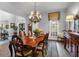 Spacious dining room featuring a chandelier, decorative curtains, and wooden table at 1220 Waterfall Nw Ln, Acworth, GA 30101