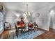 Elegant dining room with wood paneling, chandelier, and classic furniture at 1220 Waterfall Nw Ln, Acworth, GA 30101
