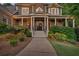 Inviting entrance with a covered porch, stone pillars, and manicured landscaping at 1220 Waterfall Nw Ln, Acworth, GA 30101