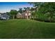 Beautiful two-story home featuring a stone facade, covered porch, and lush green lawn at 1220 Waterfall Nw Ln, Acworth, GA 30101