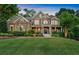 Charming two-story home with a combination of stone and siding, complemented by lush landscaping and a well-manicured lawn at 1220 Waterfall Nw Ln, Acworth, GA 30101