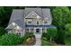 Stately two-story home with a stone and siding facade, well-maintained landscaping, and a welcoming front porch at 1220 Waterfall Nw Ln, Acworth, GA 30101