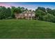 Beautifully landscaped front yard with mature trees surrounding this traditional home at 1220 Waterfall Nw Ln, Acworth, GA 30101