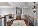 Spacious upstairs hallway with hardwood floors, elegant railings, and decorative lighting at 1220 Waterfall Nw Ln, Acworth, GA 30101