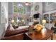 Open-concept living room featuring built-in shelving, fireplace, and lots of natural light at 1220 Waterfall Nw Ln, Acworth, GA 30101