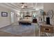 Spacious main bedroom featuring tray ceilings, ceiling fan, neutral color scheme, and many windows at 1220 Waterfall Nw Ln, Acworth, GA 30101