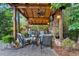 Outdoor living space with fireplace, wood ceiling, fan, comfortable seating and grilling area at 1220 Waterfall Nw Ln, Acworth, GA 30101