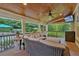 Outdoor living area featuring a covered porch with comfortable seating, a ceiling fan, and an outdoor television at 1220 Waterfall Nw Ln, Acworth, GA 30101