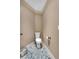 Cozy powder room featuring a white toilet, neutral walls, and a decorative rug at 1220 Waterfall Nw Ln, Acworth, GA 30101