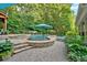 Beautiful outdoor swimming pool with stone accents, a relaxing lounge chair, and well-maintained landscaping at 1220 Waterfall Nw Ln, Acworth, GA 30101
