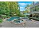 Backyard features a stunning swimming pool, spa, and lounge area, perfect for relaxation and entertainment at 1220 Waterfall Nw Ln, Acworth, GA 30101