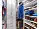 Walk-In closet featuring hardwood floors, built-in shelving, and plenty of hanging and folded storage at 1220 Waterfall Nw Ln, Acworth, GA 30101