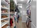 Large Walk-In closet featuring hardwood floors, built-in shelving, a mirror, and plenty of hanging storage at 1220 Waterfall Nw Ln, Acworth, GA 30101
