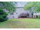 Large backyard with a deck, lawn and lush green trees surrounding the property at 1706 Brandon Lee Sw Way, Marietta, GA 30008