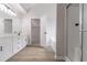 Bright bathroom featuring double sink vanity, wood look floors, and a shower with glass doors at 1706 Brandon Lee Sw Way, Marietta, GA 30008