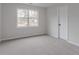 This bedroom features neutral carpet and a window overlooking a neighborhood at 1706 Brandon Lee Sw Way, Marietta, GA 30008