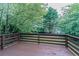 Backyard deck featuring a stained finish, horizontal railings and a lush green backdrop at 1706 Brandon Lee Sw Way, Marietta, GA 30008