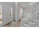 Bright entryway featuring a staircase with white railings, wood floors, and a modern front door at 1706 Brandon Lee Sw Way, Marietta, GA 30008