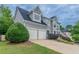 Gray two-story home featuring a two-car garage, manicured landscaping, and a classic architectural design at 1706 Brandon Lee Sw Way, Marietta, GA 30008