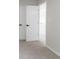 Hallway with carpet, neutral walls, and white doors at 1706 Brandon Lee Sw Way, Marietta, GA 30008