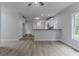 Open-concept living room with a kitchen area, wood floors, and a modern design aesthetic at 1706 Brandon Lee Sw Way, Marietta, GA 30008