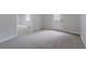 Spacious living room featuring neutral walls, carpet, and walk out to patio at 1706 Brandon Lee Sw Way, Marietta, GA 30008