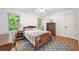 Bedroom featuring windows, wooden furniture, and a patterned rug at 2010 Pearwood Path, Roswell, GA 30076