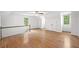 Large bonus room with hardwood floors, natural light, and staircase at 2010 Pearwood Path, Roswell, GA 30076