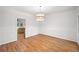 Spacious dining room with hardwood floors, white trim, and modern light fixture at 2010 Pearwood Path, Roswell, GA 30076