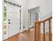 Bright entryway featuring hardwood floors, a white door with sidelights, and a staircase at 2010 Pearwood Path, Roswell, GA 30076